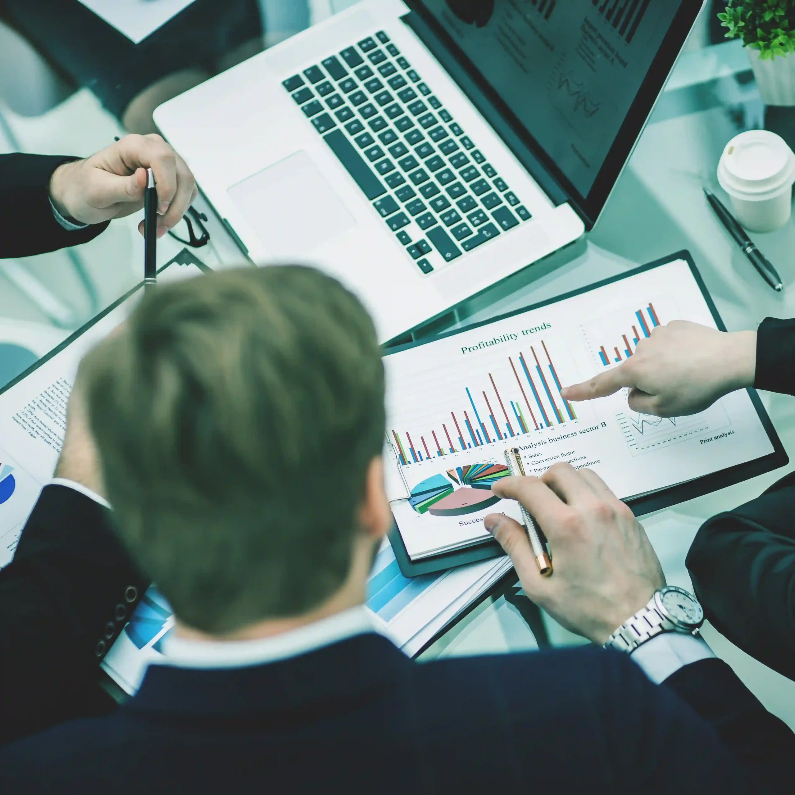 Financial professionals reviewing reports with secure business technology